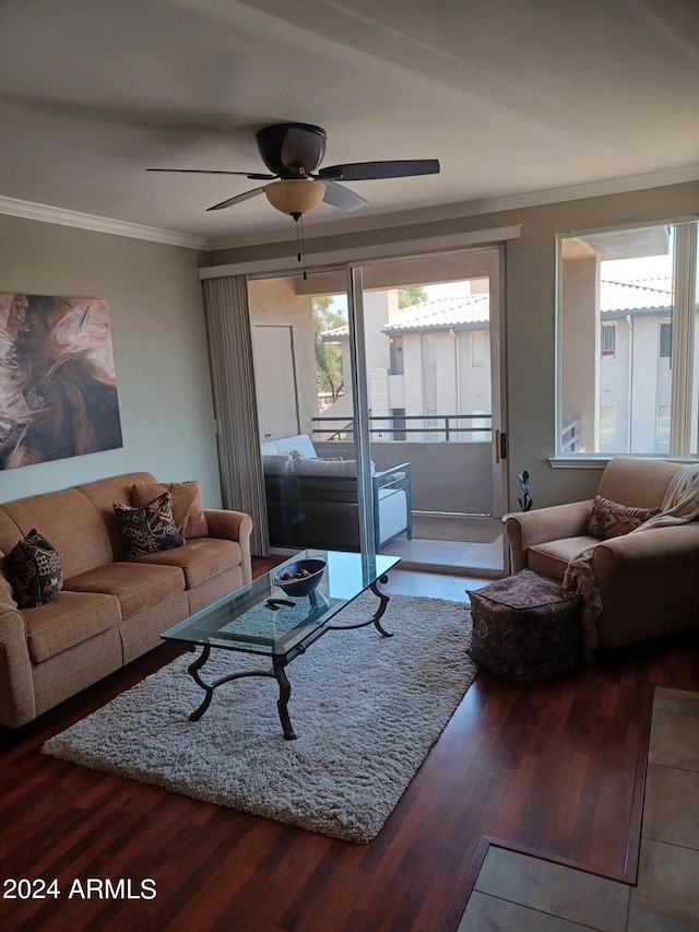 living room featuring hardwood / wood-style flooring, ceiling fan, and crown molding