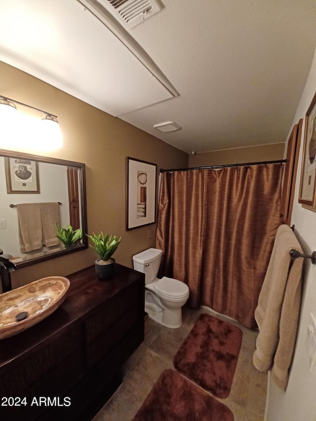 bathroom featuring tile patterned floors, vanity, and toilet