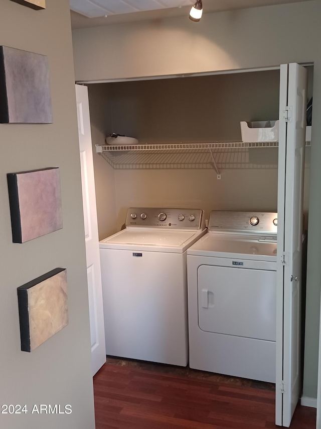 washroom featuring washing machine and dryer and dark hardwood / wood-style floors