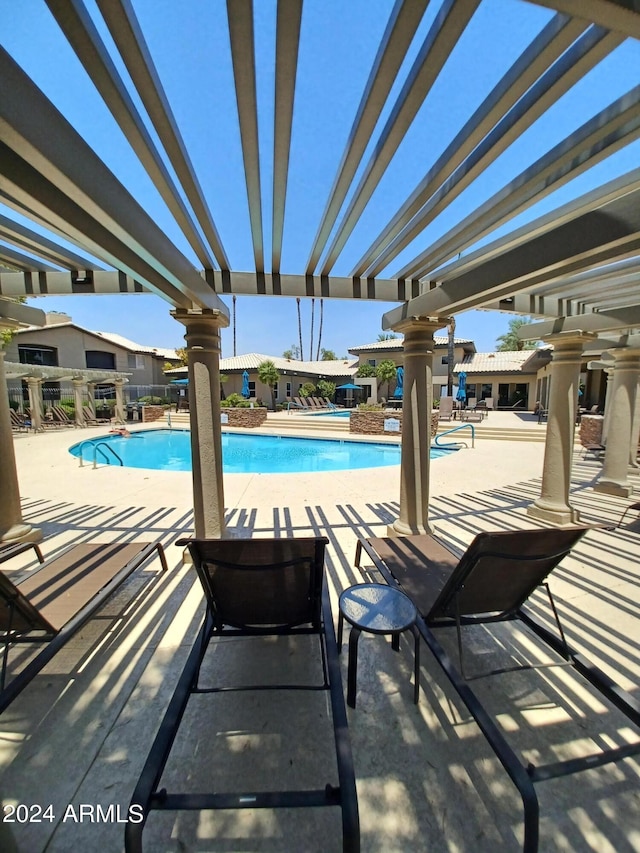 view of pool with a pergola and a patio