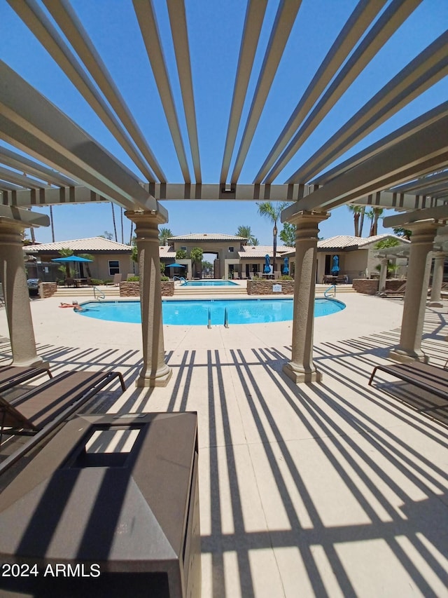 view of swimming pool with a pergola and a patio