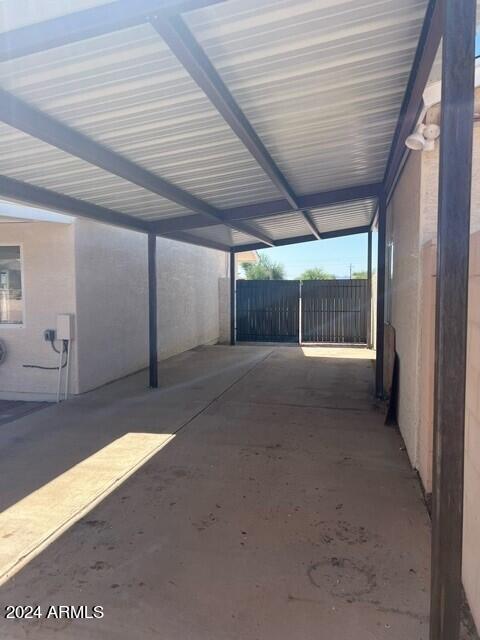 view of parking / parking lot featuring a carport