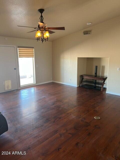 spare room with ceiling fan and dark hardwood / wood-style flooring