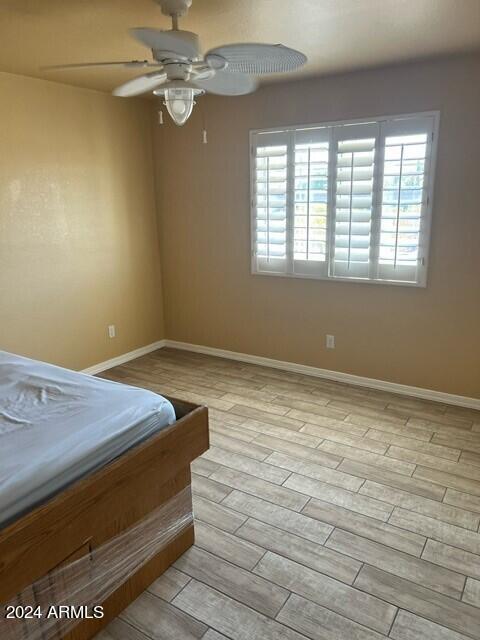 unfurnished bedroom featuring light hardwood / wood-style flooring and ceiling fan