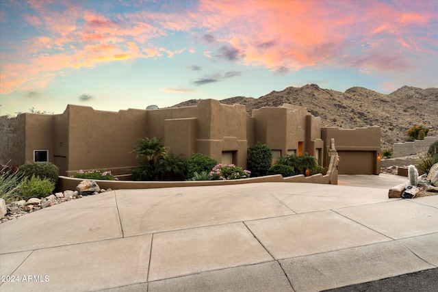 pueblo revival-style home featuring a mountain view