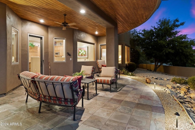 patio terrace at dusk with ceiling fan and an outdoor hangout area