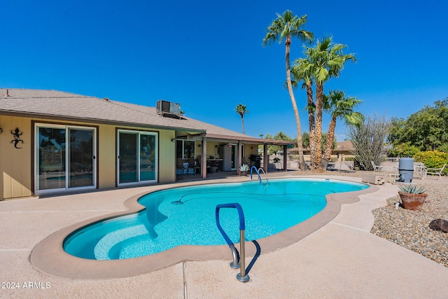 view of swimming pool featuring central AC and a patio area