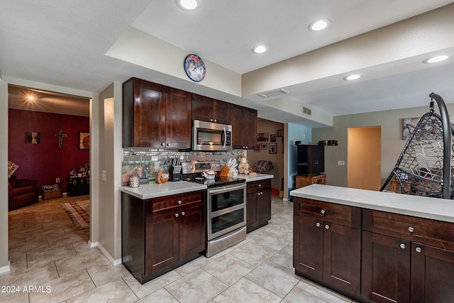 kitchen featuring dark brown cabinetry, appliances with stainless steel finishes, and backsplash