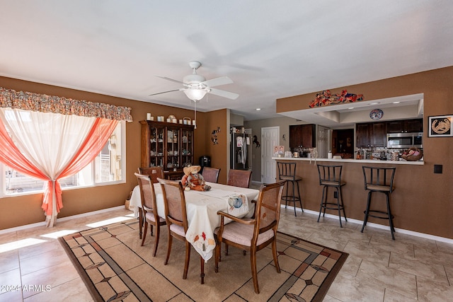 dining space with ceiling fan