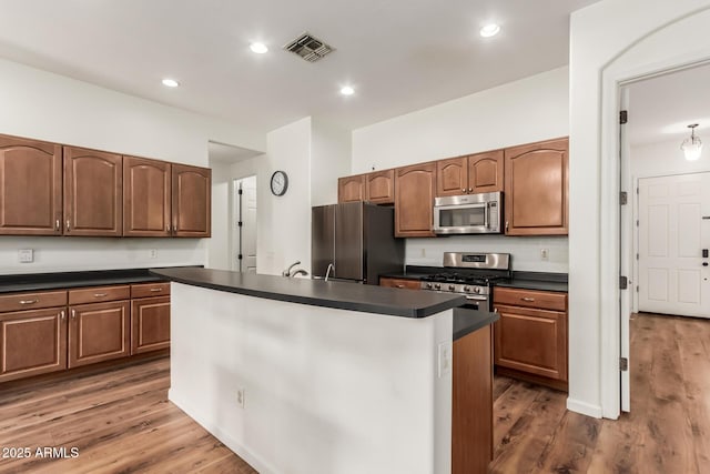 kitchen featuring wood finished floors, visible vents, recessed lighting, appliances with stainless steel finishes, and dark countertops