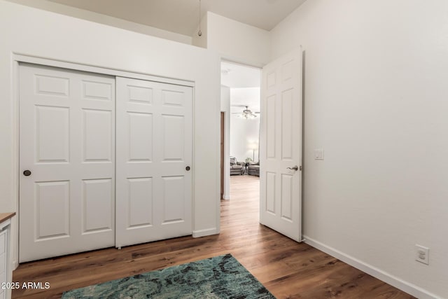 bedroom featuring a closet, baseboards, and wood finished floors