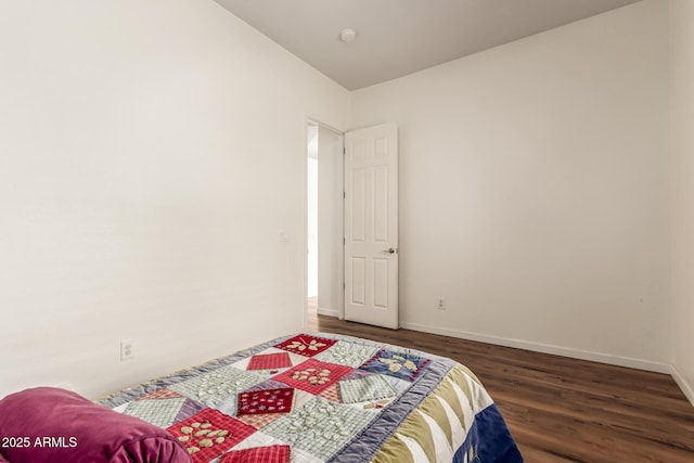 bedroom featuring wood finished floors and baseboards