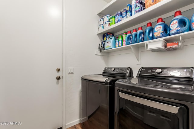 clothes washing area with laundry area, wood finished floors, separate washer and dryer, and baseboards