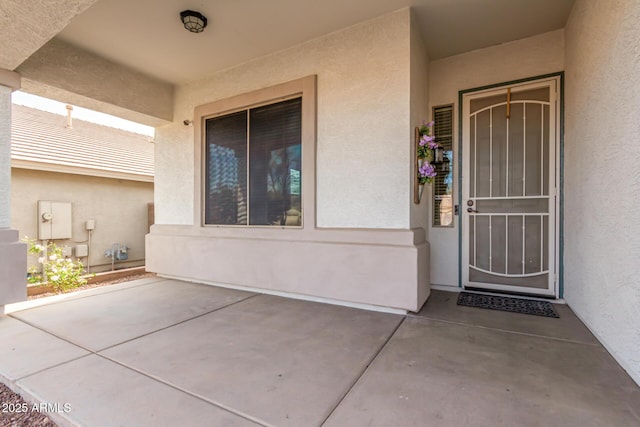 entrance to property with stucco siding