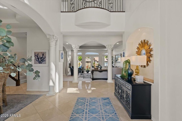 2135 E Clipper Ln, Gilbert, AZ 85234 - foyer entrance featuring decorative columns, a towering ceiling, light tile patterned floors, arched walkways, and recessed lighting