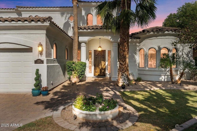 2135 E Clipper Ln, Gilbert, AZ 85234 - mediterranean / spanish house with stucco siding, an attached garage, and a tiled roof