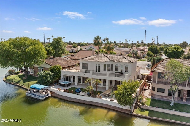 2135 E Clipper Ln, Gilbert, AZ 85234 - back of property featuring a balcony, a water view, a patio, stucco siding, and a residential view