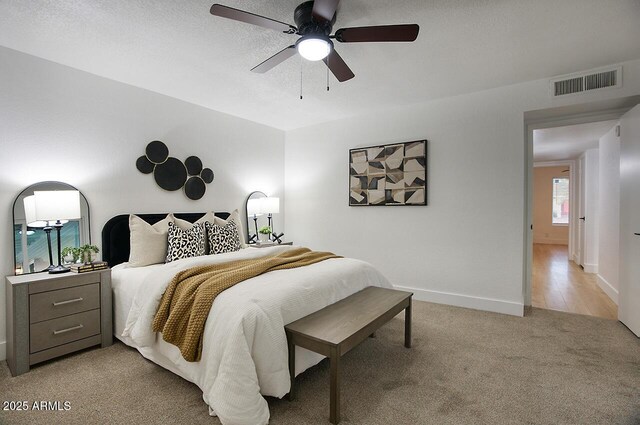 bedroom featuring ceiling fan and light colored carpet