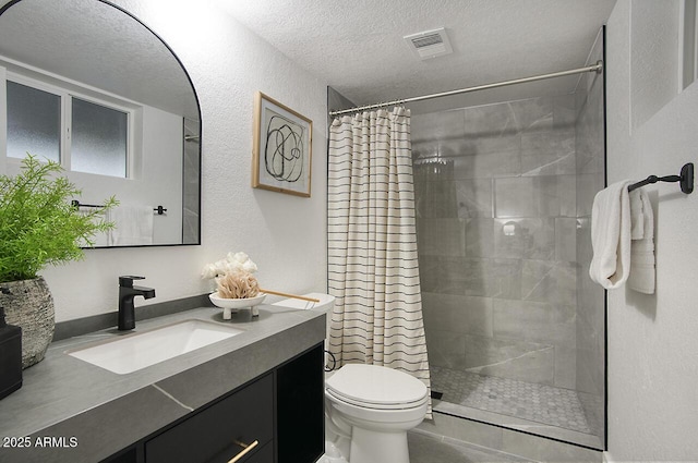 bathroom featuring a textured ceiling, toilet, vanity, and a shower with curtain