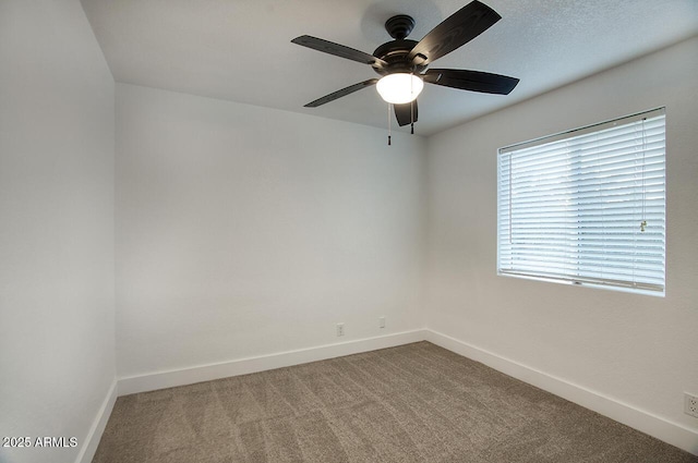 empty room with ceiling fan and carpet