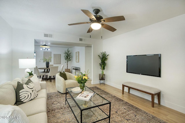 living room featuring ceiling fan and wood-type flooring