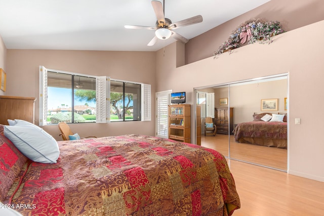 bedroom featuring a closet, ceiling fan, vaulted ceiling, and light wood-type flooring