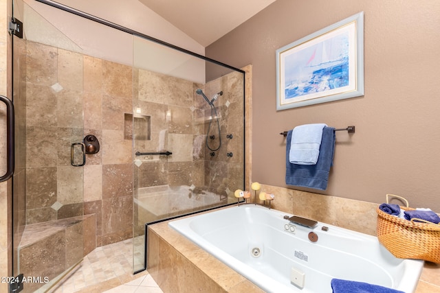 bathroom with tile patterned flooring, lofted ceiling, and separate shower and tub