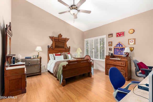 bedroom with ceiling fan, lofted ceiling, and light hardwood / wood-style floors