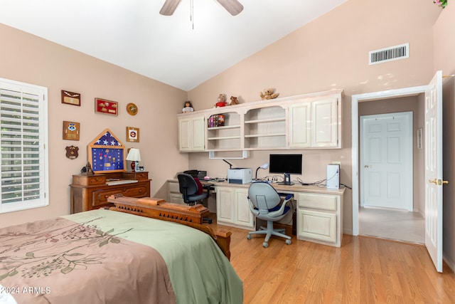 bedroom with built in desk, ceiling fan, vaulted ceiling, and light hardwood / wood-style flooring