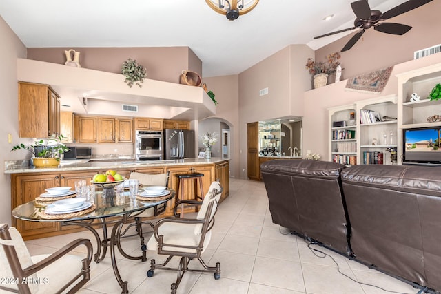 interior space featuring high vaulted ceiling and ceiling fan