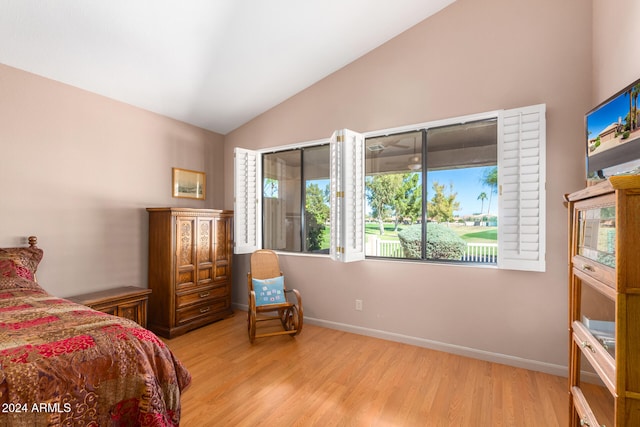 bedroom with lofted ceiling and light wood-type flooring