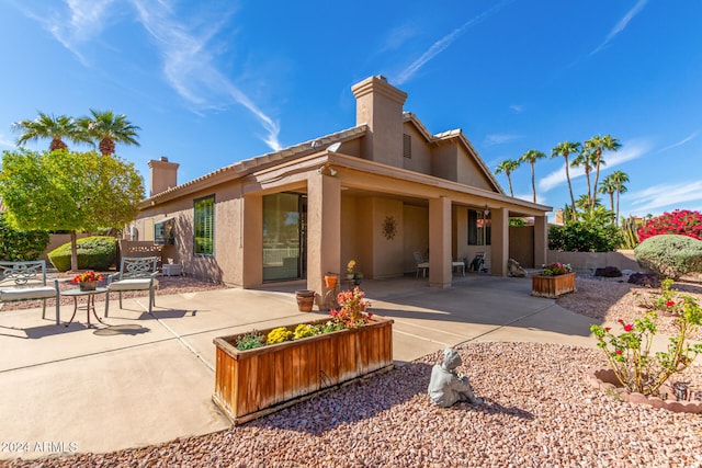 back of property featuring a patio