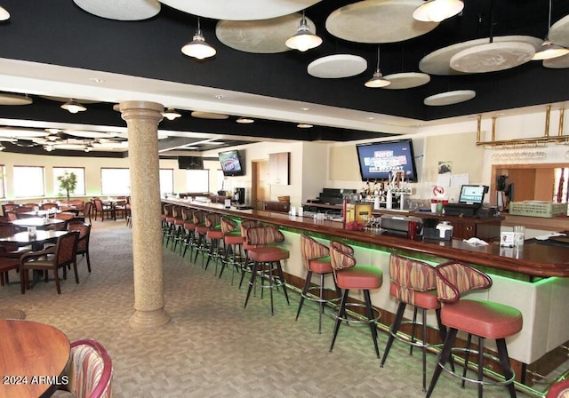 bar featuring carpet and decorative columns