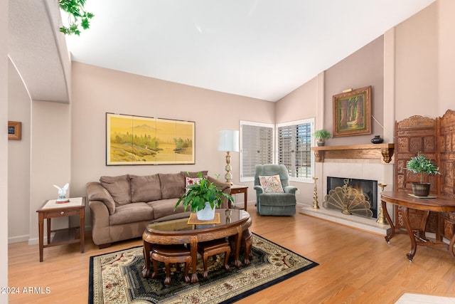 living room with light hardwood / wood-style flooring and vaulted ceiling