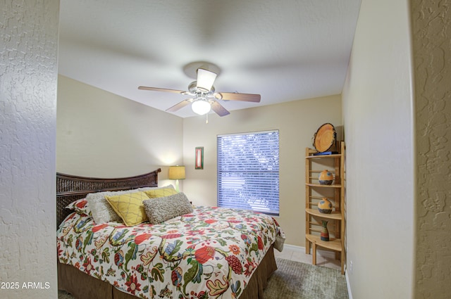 bedroom with ceiling fan and tile patterned floors