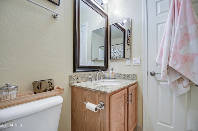 bathroom with toilet and vanity