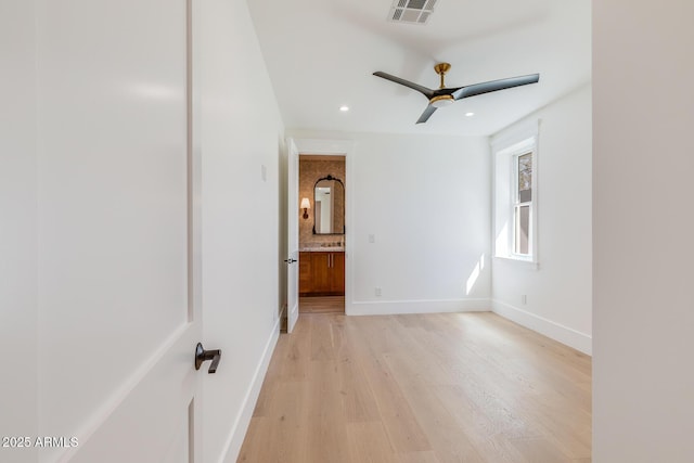 empty room featuring visible vents, baseboards, recessed lighting, ceiling fan, and light wood-style floors