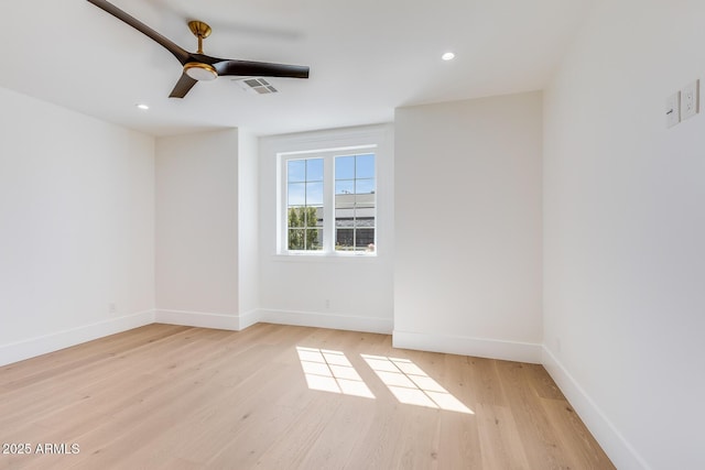 spare room featuring visible vents, light wood-style flooring, a ceiling fan, recessed lighting, and baseboards