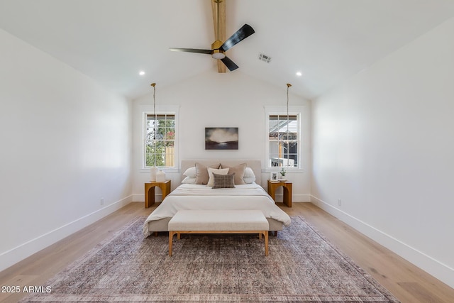 bedroom featuring lofted ceiling, light wood-style flooring, baseboards, and visible vents