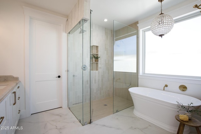 full bath featuring marble finish floor, a tile shower, recessed lighting, a freestanding bath, and vanity