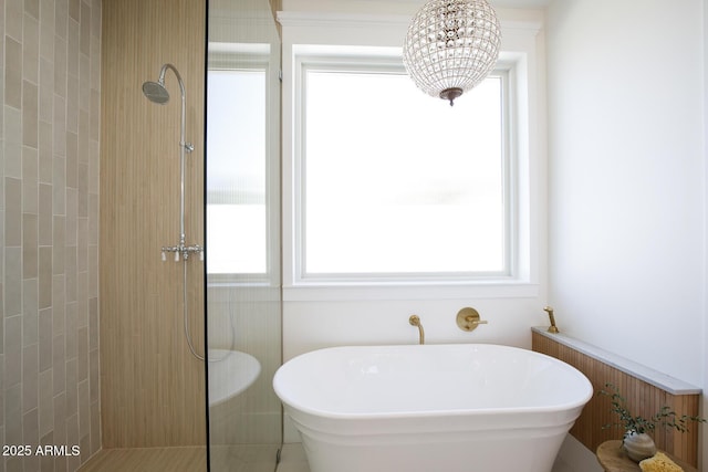 full bath with tiled shower and a freestanding bath