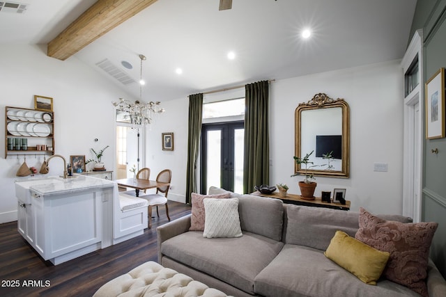 living area with lofted ceiling with beams, visible vents, plenty of natural light, and dark wood-style flooring