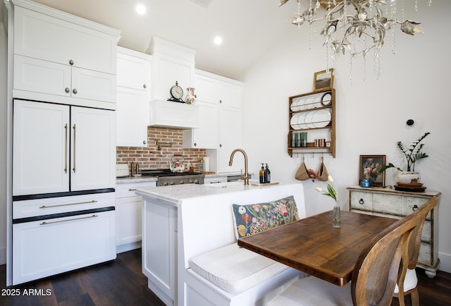 kitchen with dark wood-style floors, light countertops, white cabinetry, range, and tasteful backsplash