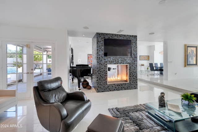 living room with a multi sided fireplace, light tile patterned floors, and french doors