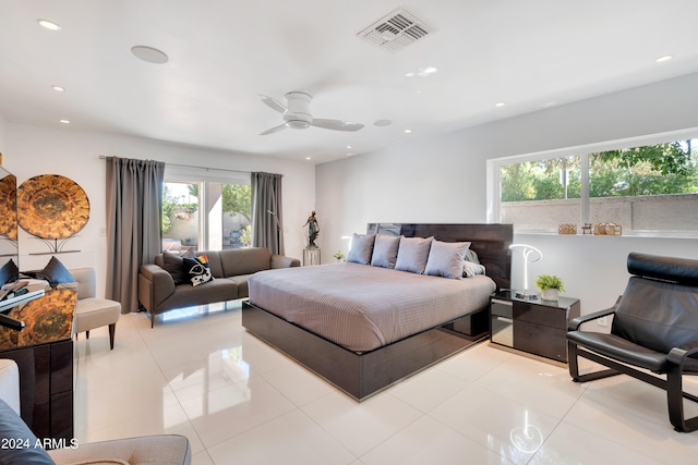 tiled bedroom featuring ceiling fan