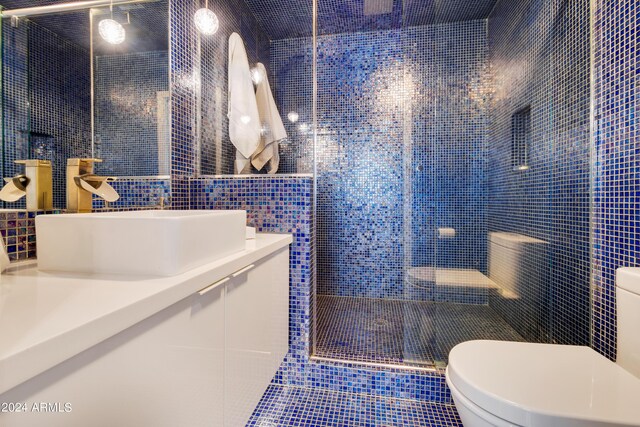 tiled bedroom featuring built in desk, a closet, and ceiling fan