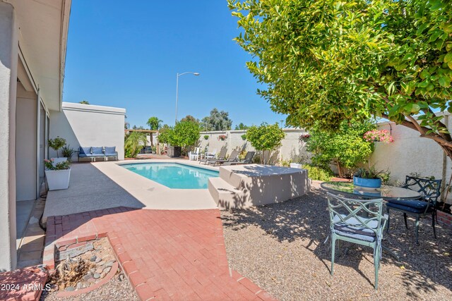 view of swimming pool with a patio area