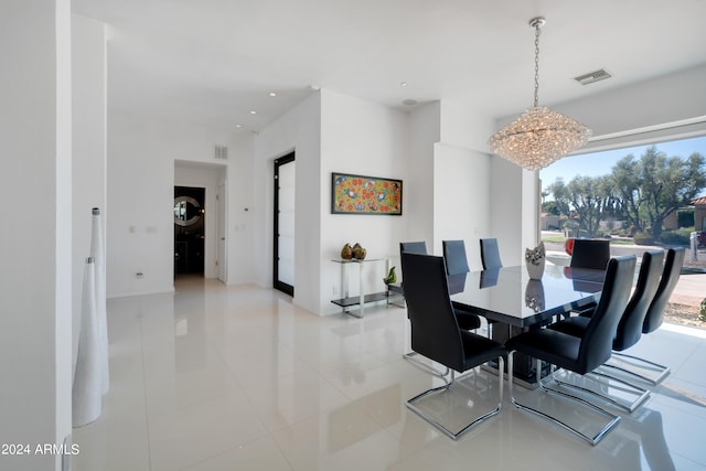 tiled dining area with a chandelier