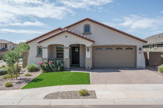 mediterranean / spanish house with a garage