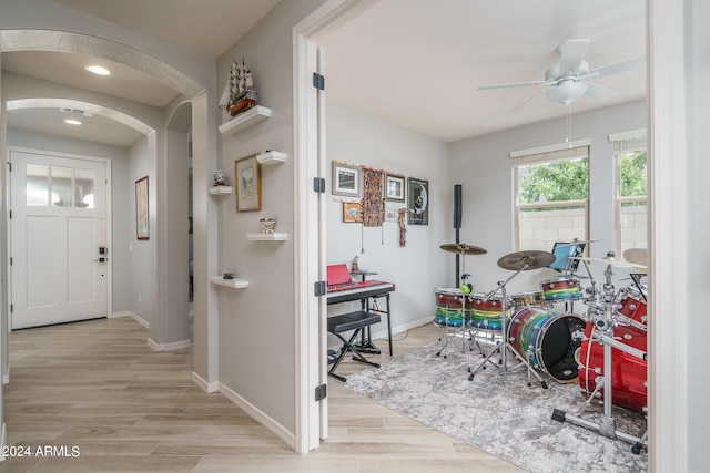 entrance foyer with ceiling fan and light wood-type flooring